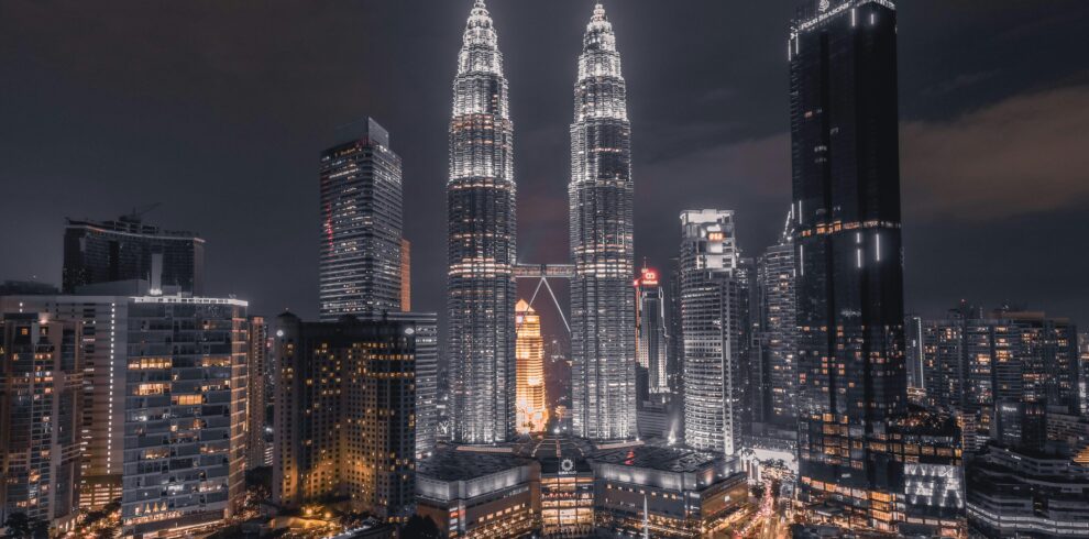 A breathtaking night view of Kuala Lumpur's skyline featuring the illuminated Petronas Towers.